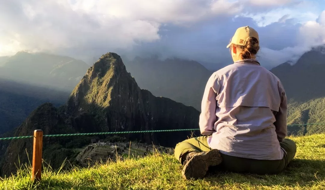 Somatic Travel Helps You Get Grounded, seated overlooking Machu Picchu