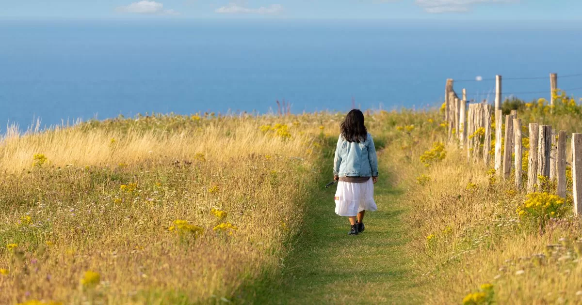 How to let go of expectations and judgement Person walking along a quiet path practicing somatic presence and releasing expectations.